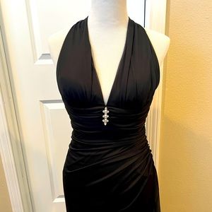Black long gown by Cache. Side zipper. Rhinestone pendant on chest.